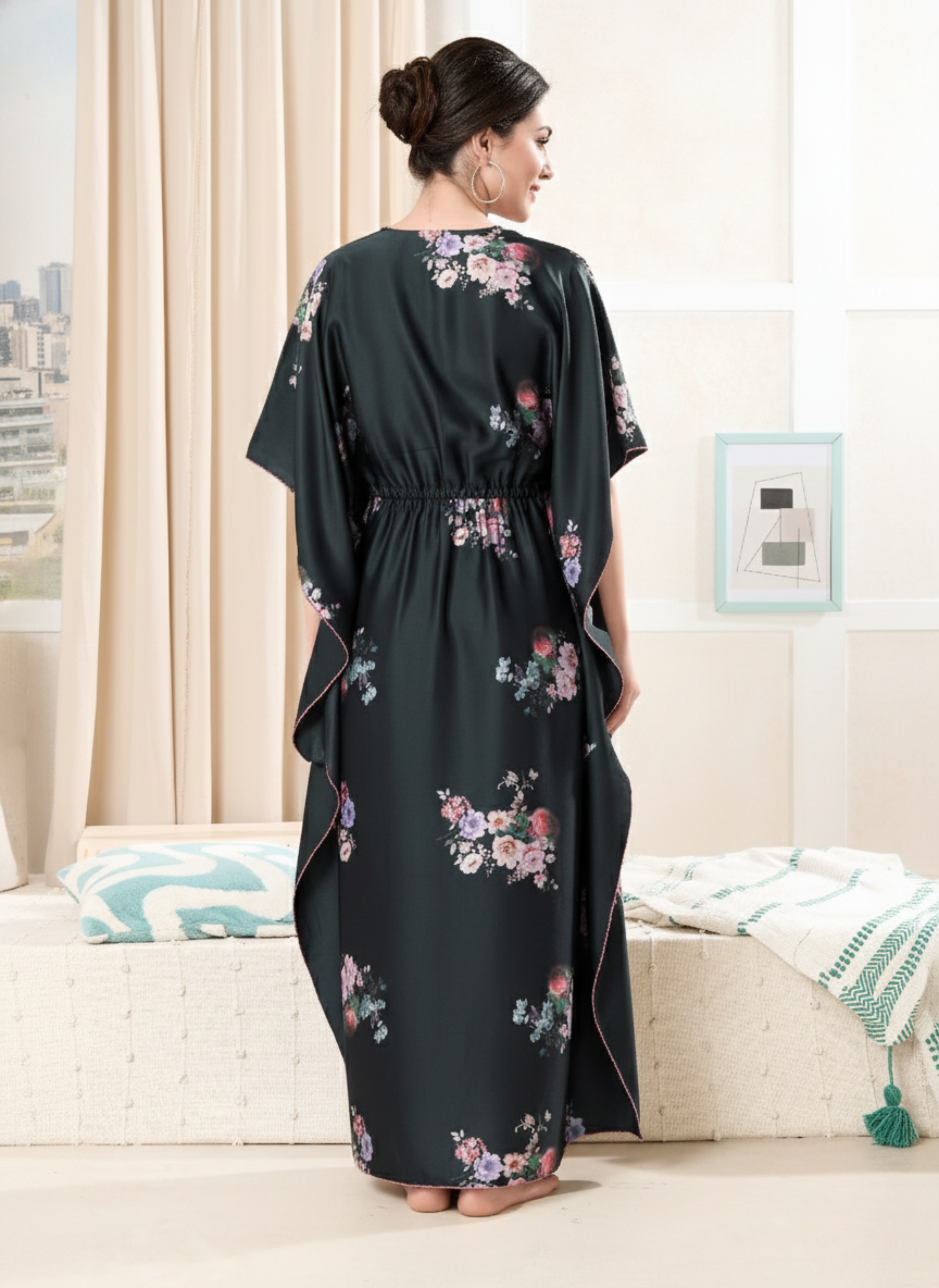 Back view of black floral satin kaftan showing flowy full length fit and pink hem trim