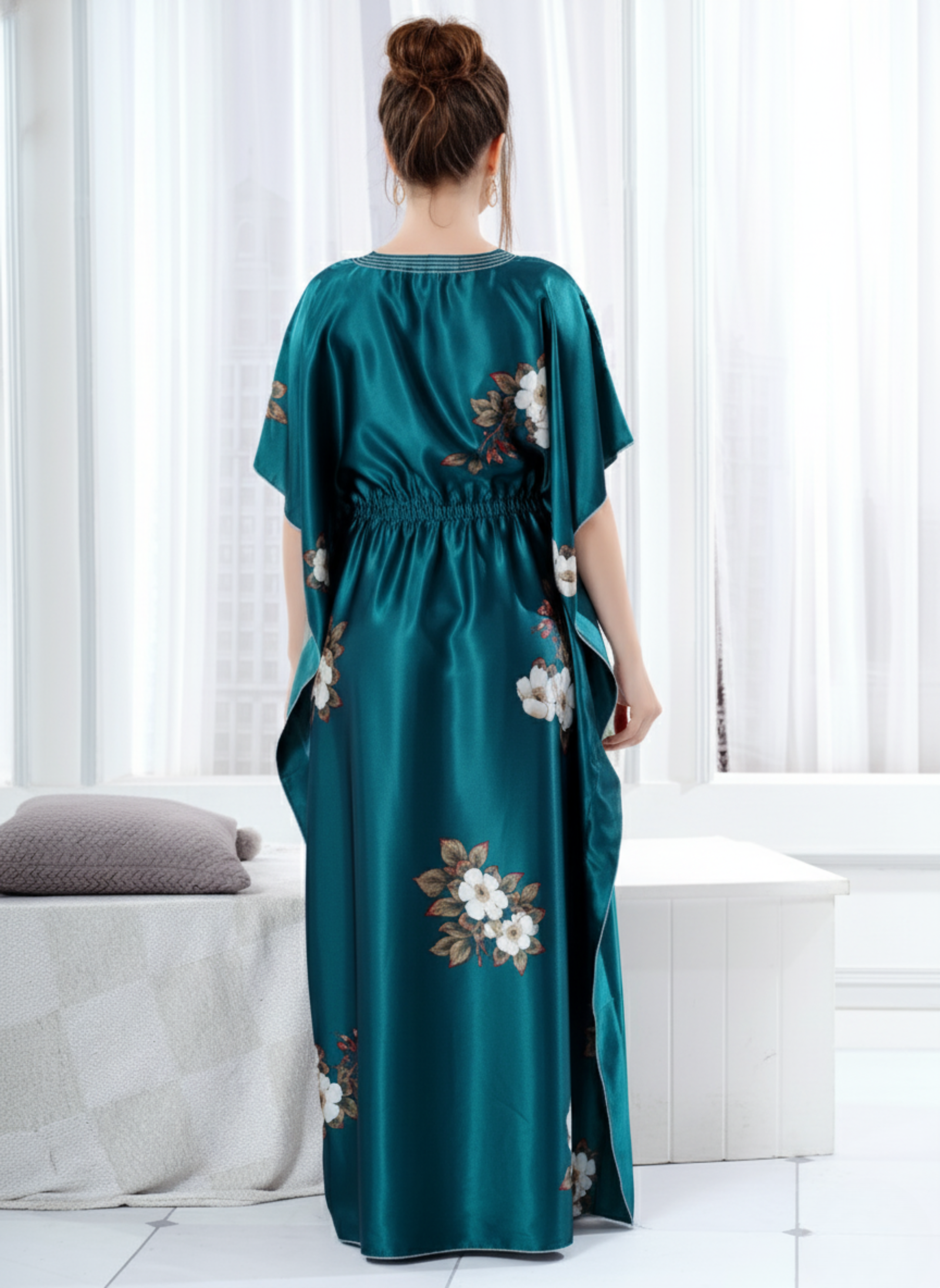 Back view of teal green floral satin kaftan showing flowy full length fit and white hem trim