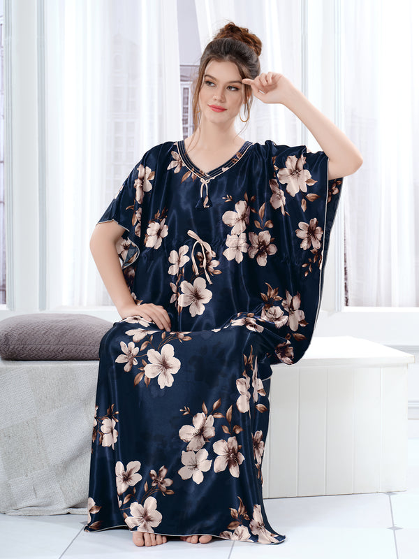 Woman sitting wearing a navy blue floral satin kaftan for women with drawstring waist.
