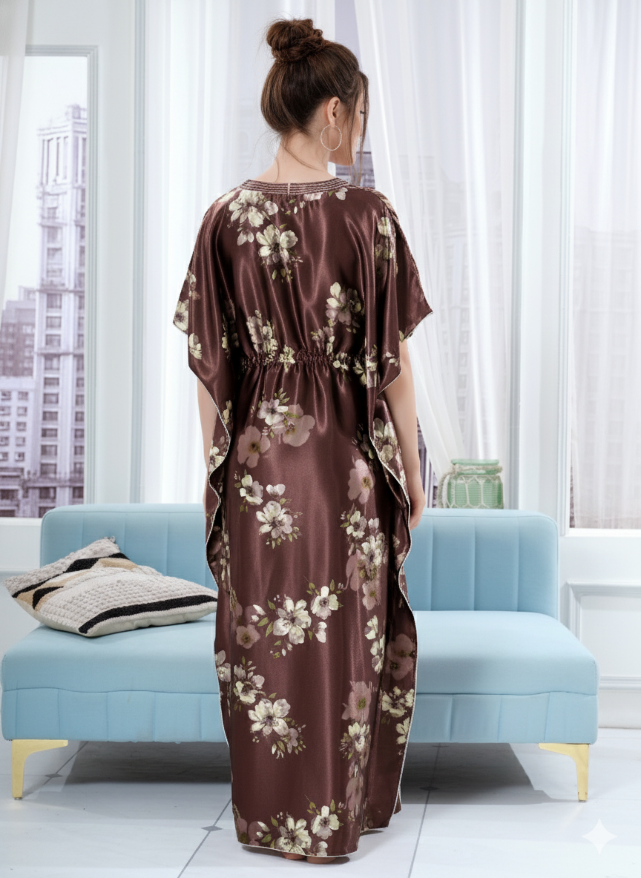 Back view of chocolate brown floral satin kaftan showing flowy full length fit and white hem trim