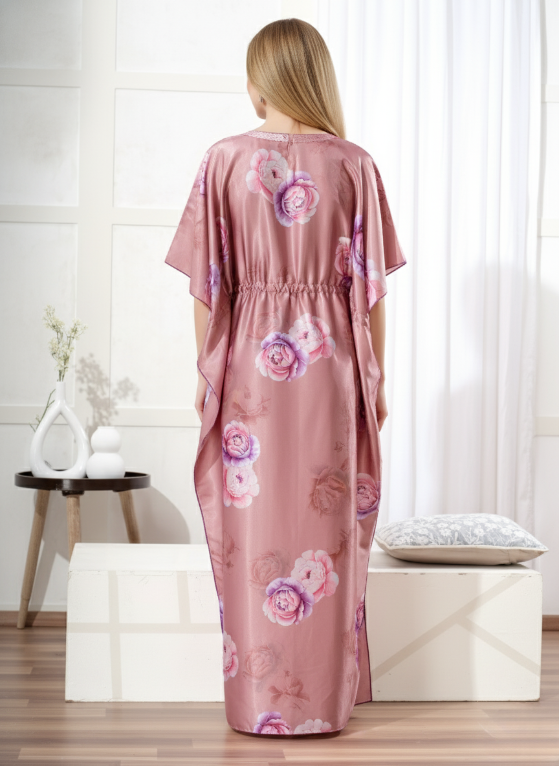 Back view of dusty pink floral satin kaftan showing flowy full length fit and purple hem trim