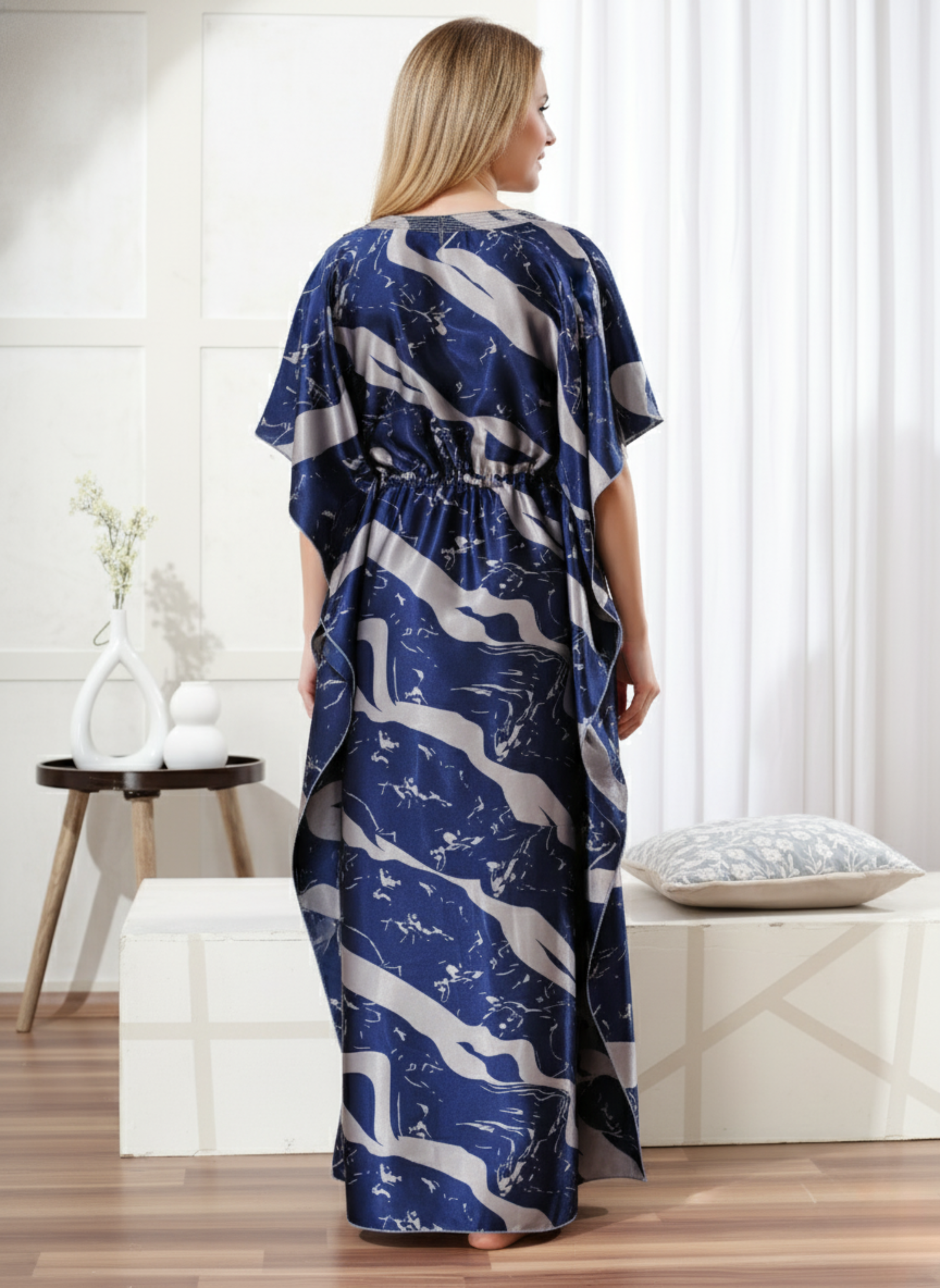 Back view of dark blue satin kaftan showing flowy full length fit and elegant drape