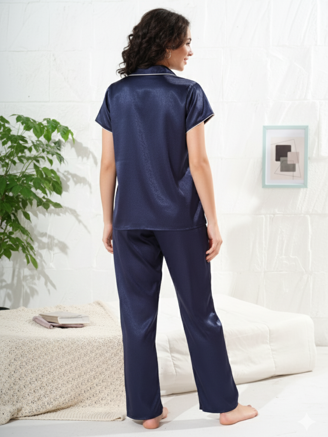 Back view of navy blue satin pajama set showing relaxed fit and silky texture