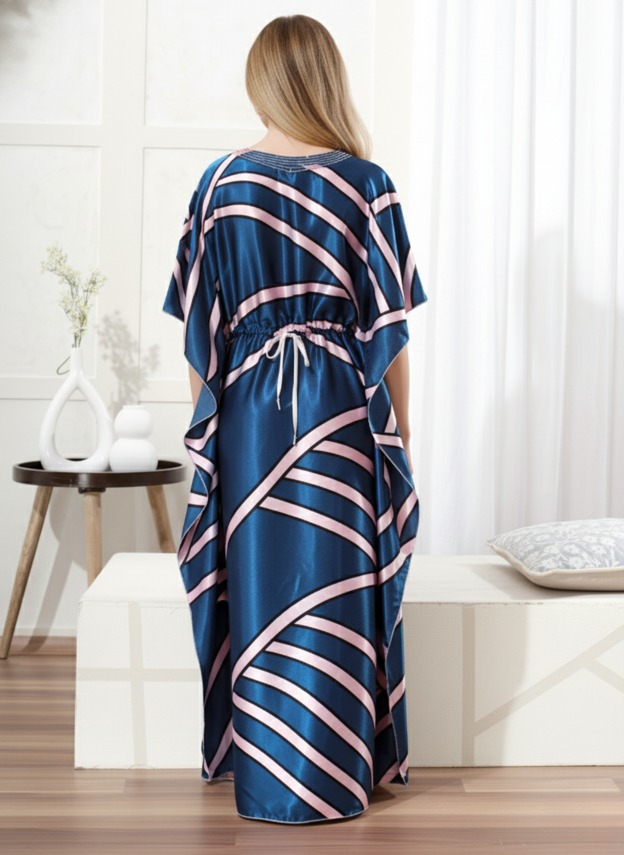 Back view of luxe blue striped satin kaftan showing flowy full length fit and geometric pattern