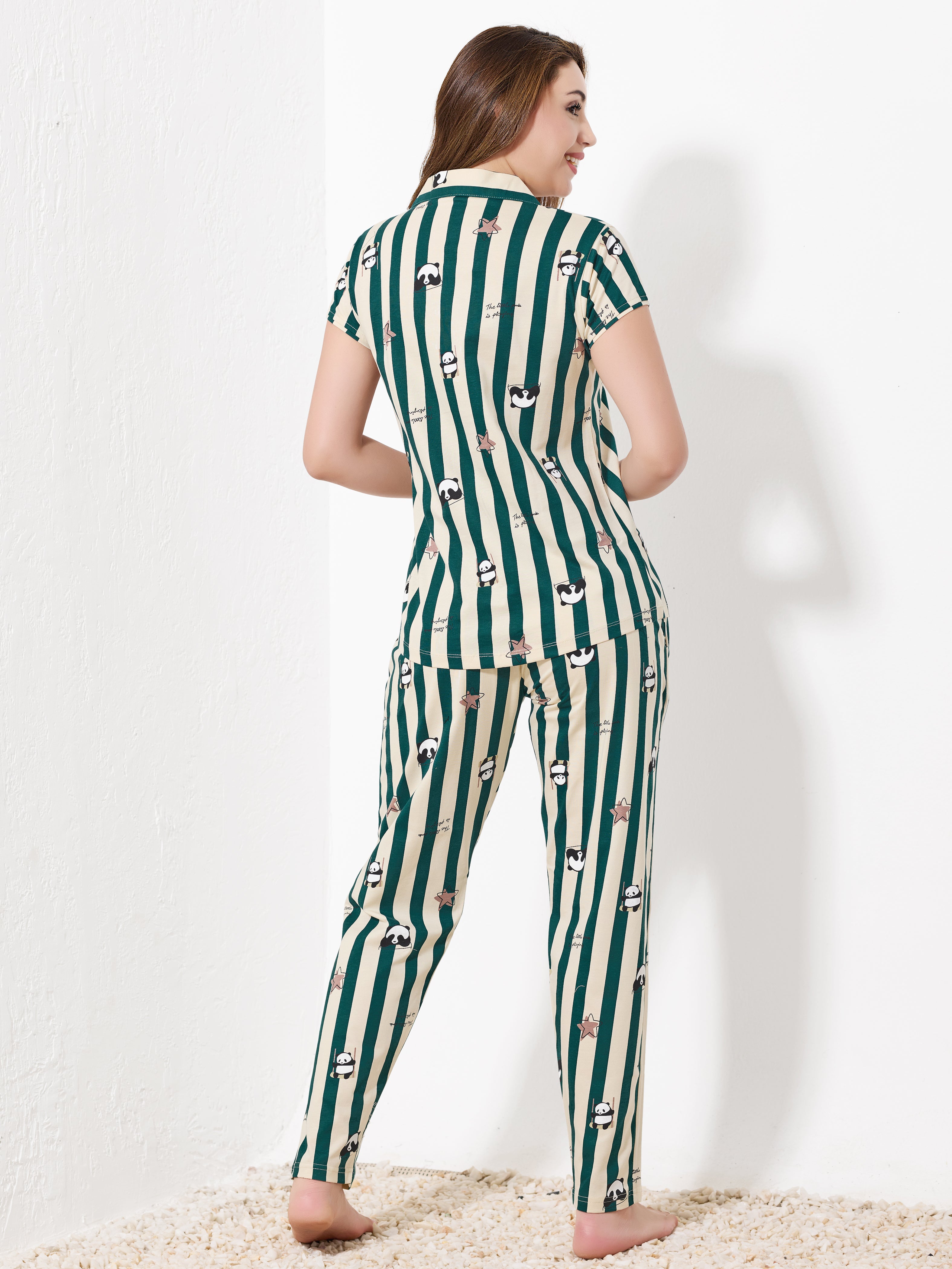 Back view of green and beige striped pajama set showing relaxed fit and cute print