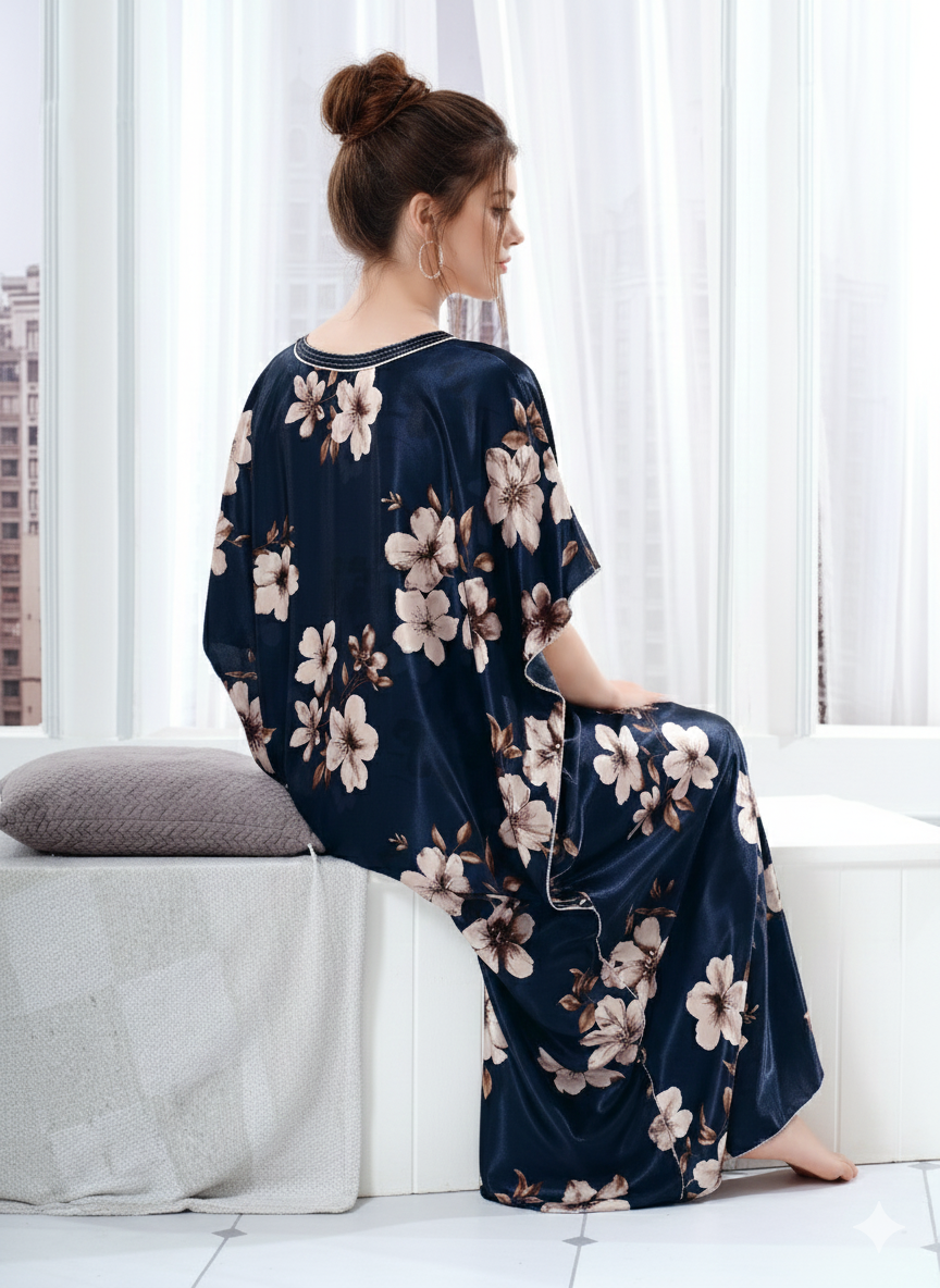 Close up of navy blue satin fabric texture showing beige floral print on luxurious loungewear.