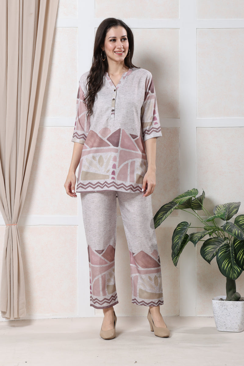 Model wearing grey linen geometric co-ord set for women with light pink print on tunic and straight trousers