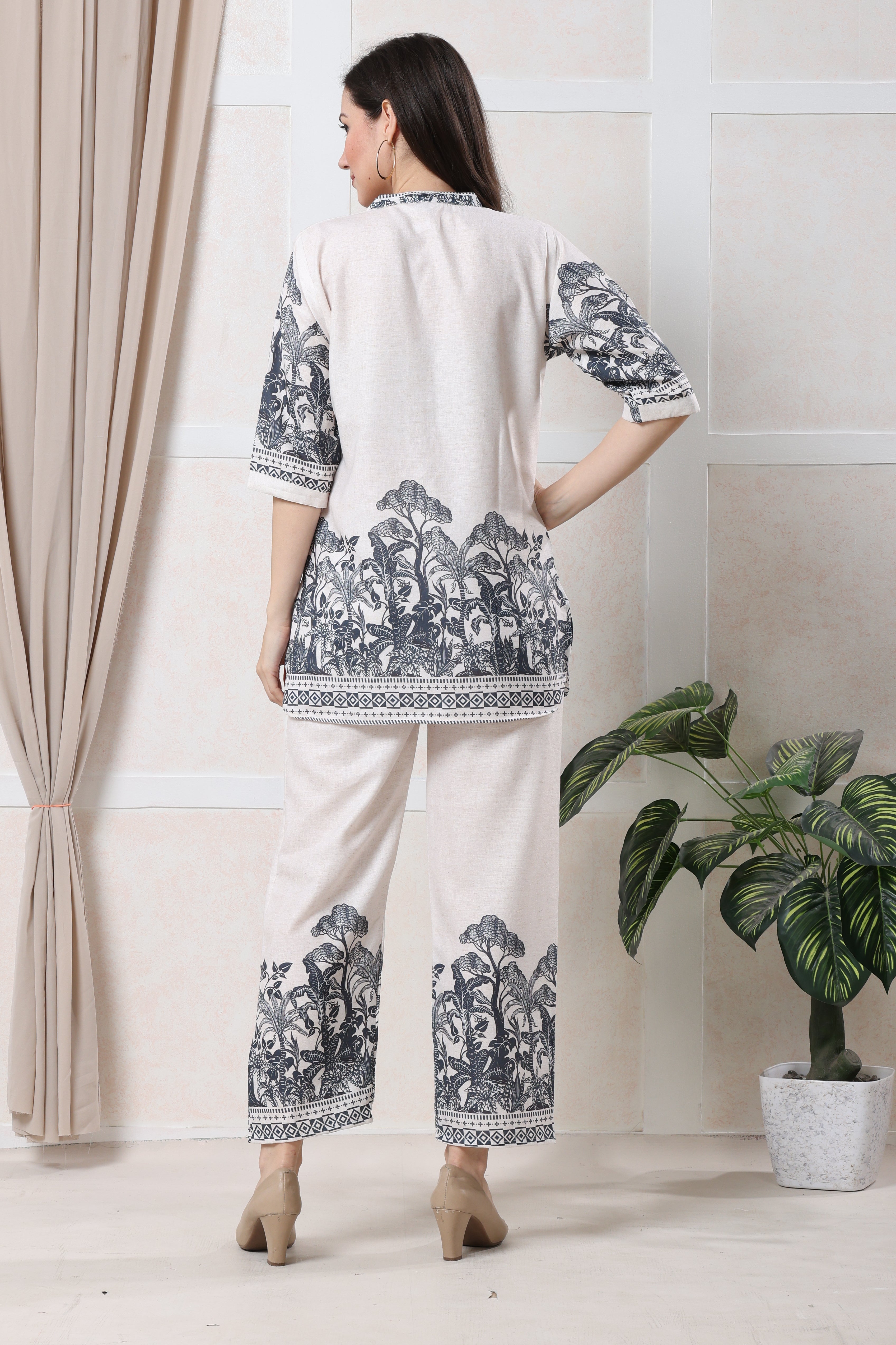 Back view of white linen floral co-ord set showing relaxed tunic and trouser fit