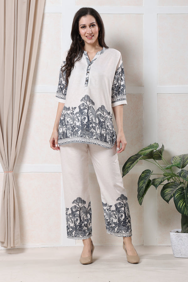 Model wearing white linen floral co-ord set for women with deep grey print on tunic and wide-leg trousers