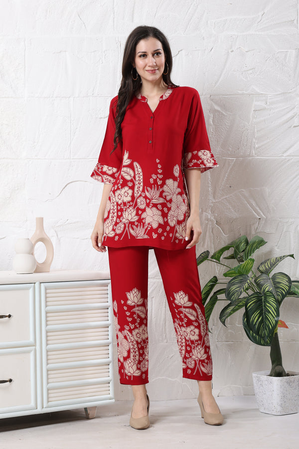Model wearing vibrant red linen floral co-ord set for women with white print on tunic and straight trousers