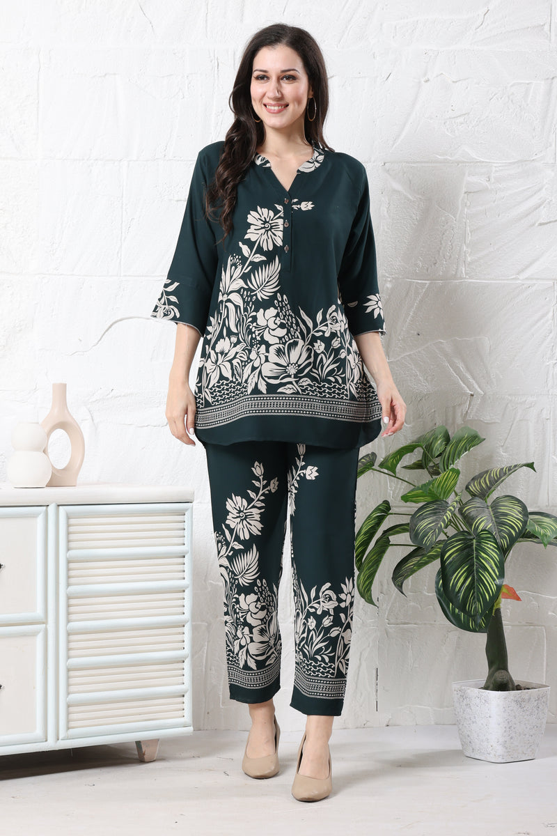 Model wearing deep green linen floral co-ord set for women with white botanical print on tunic and straight trousers