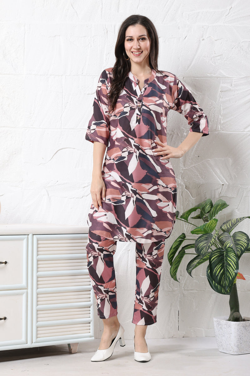 Model wearing maroon linen printed co-ord set for women with abstract leafy pattern on tunic and tapered trousers