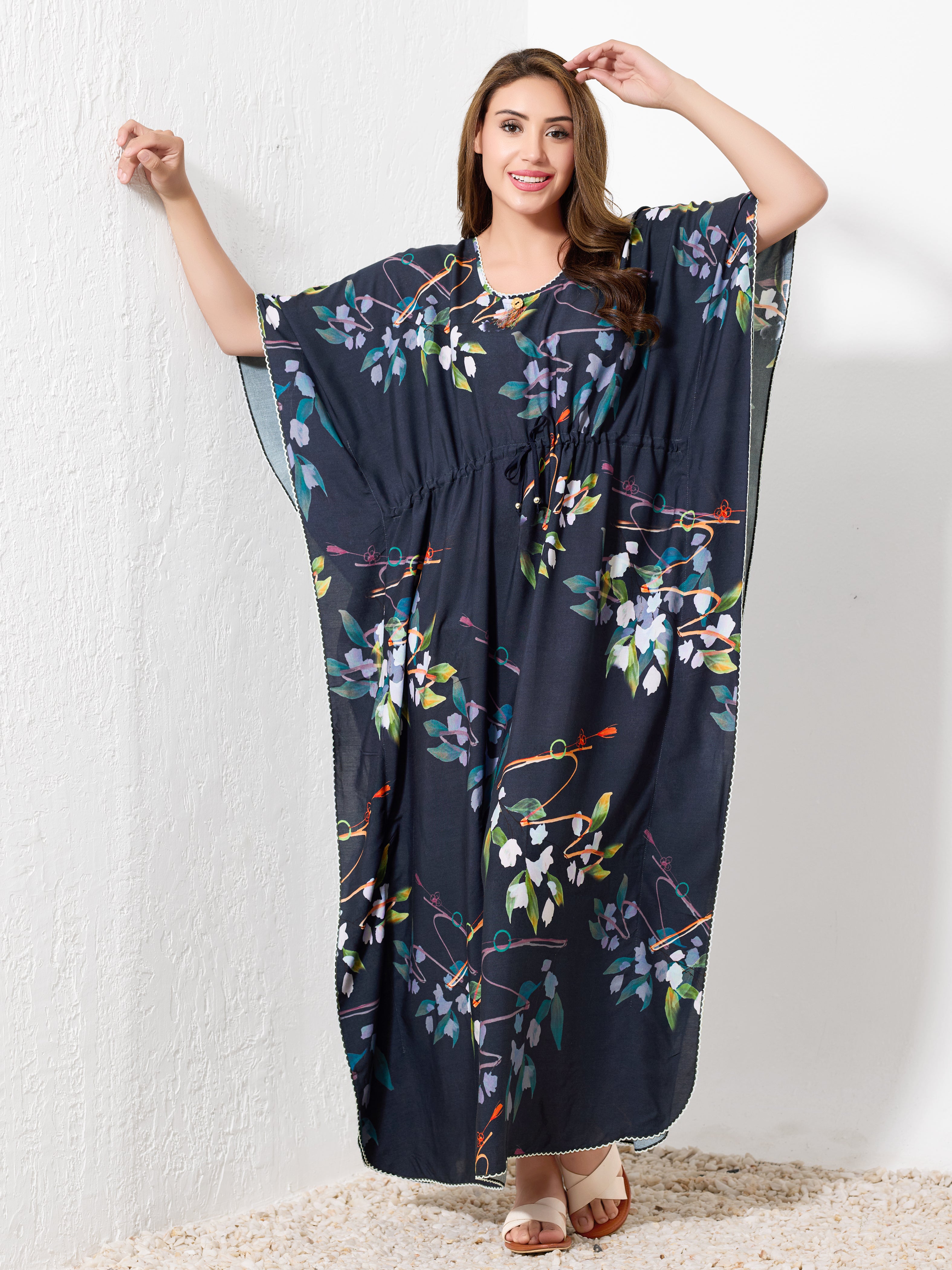 Model standing wearing navy blue premium cotton kaftan for women with botanical floral print