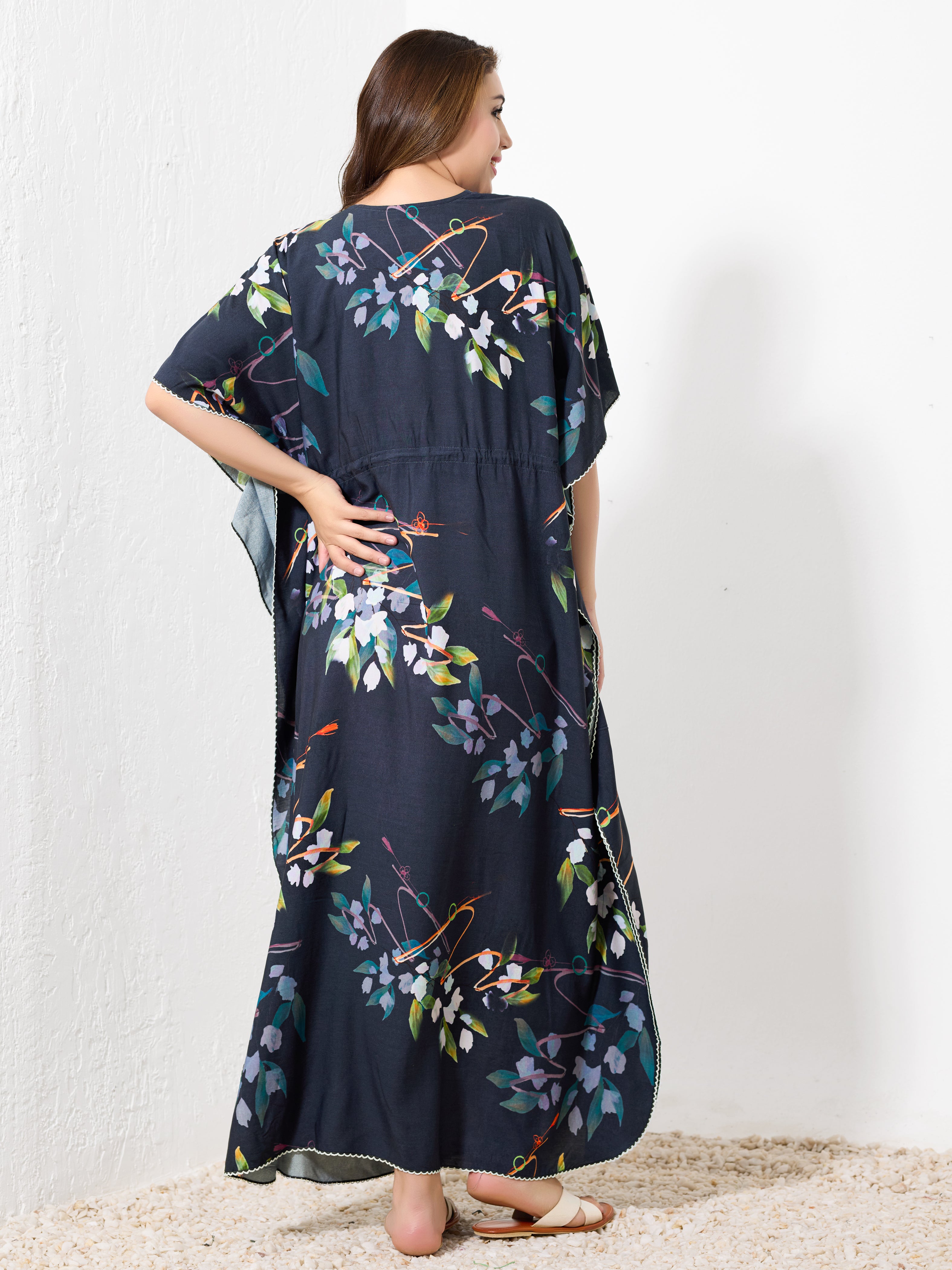 Back view of navy blue cotton floral kaftan showing flowy full length fit and white hem trim