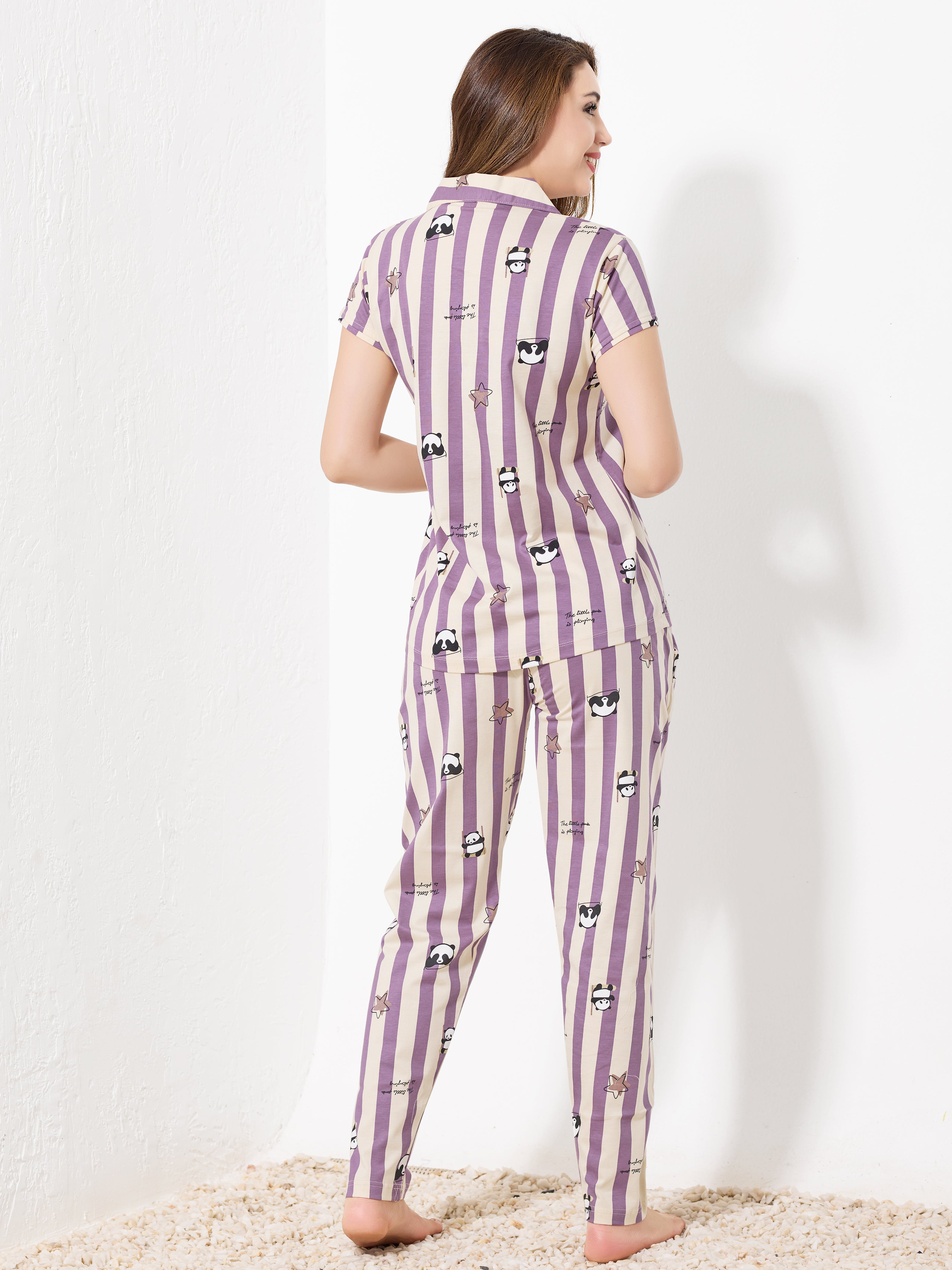 Back view of purple and beige striped satin pajama set showing relaxed fit and playful pattern