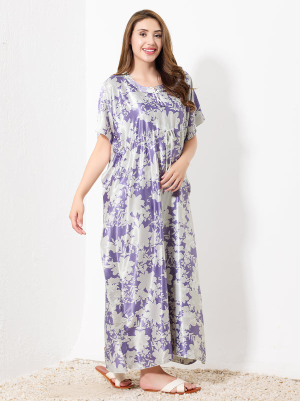 A woman with long brown hair wears the Priincezz Nightwear Purple & White Floral Kaftan as elegant loungewear, paired with white sandals, standing and smiling against a plain white background.
